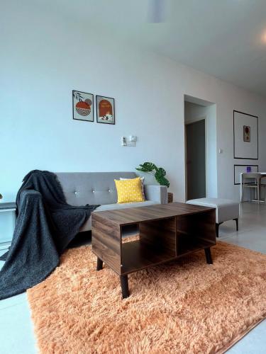 a living room with a couch and a coffee table at Meritus - Perai, Penang in Perai
