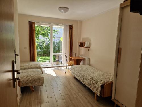 a hotel room with two beds and a window at Emides in Pobierowo