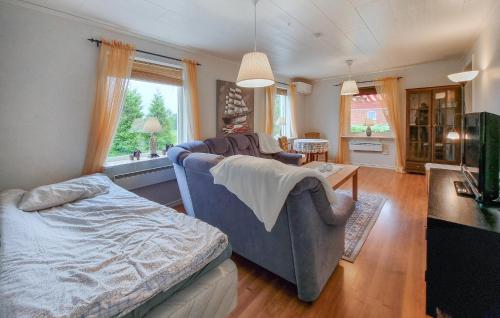 a living room with a couch and a table at 2 Bedroom Cozy Home In Falköping in Falköping