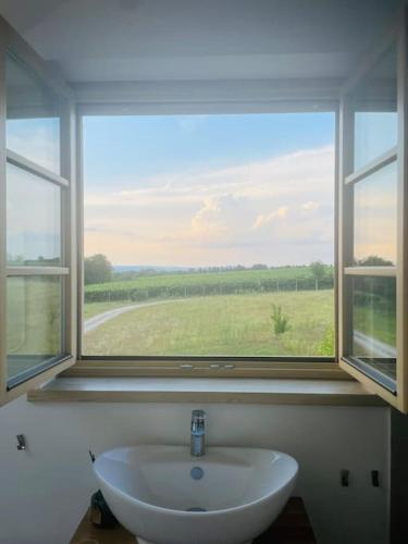 a sink in a bathroom with a large window at Mimi vendégház in Balatonlelle