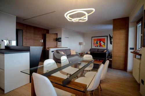 a dining room and living room with a table and chairs at Luxury flat in Cervinia 34 in Breuil-Cervinia