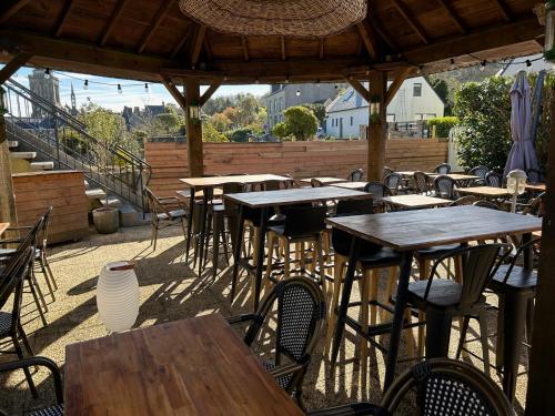 a group of tables and chairs on a patio at Logis Le Prieuré in Locronan