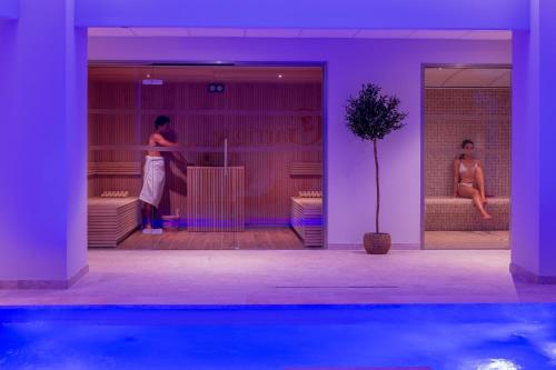 two women are standing in a room with at Garrigae Domaine de l'Esterel - piscine & SPA Cinq Mondes in Saint-Raphaël