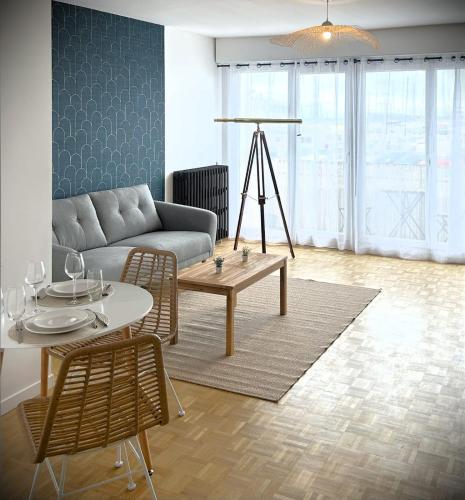 un salon avec un canapé et une table dans l'établissement La Longue Vue-Appart vue mer avec balcon-parking, au Havre