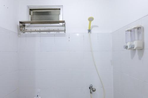 a bathroom with a sink and a window at Good Deal 2BR at 16th Floor Suites @Metro Apartment By Travelio in Bandung