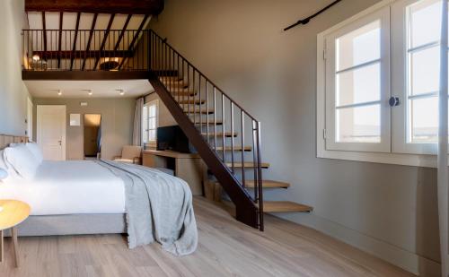 a bedroom with a large bed and a staircase at Colle Alberti Country House in Cerreto Guidi