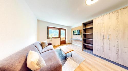 a living room with a couch and a table at Haus Moritz in Oetz