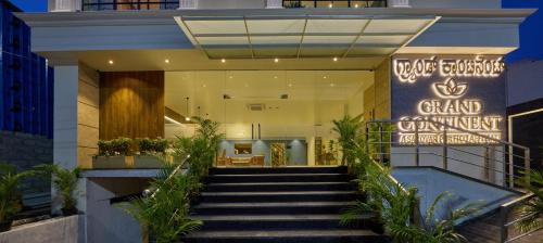 a staircase leading to a grand entrance to a building at Grand Continent Mysore A Sarovar Portico Affiliate Hotel in Mysore