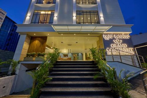 a staircase leading to a grand entrance to a building at Grand Continent Mysore A Sarovar Portico Affiliate Hotel in Mysore