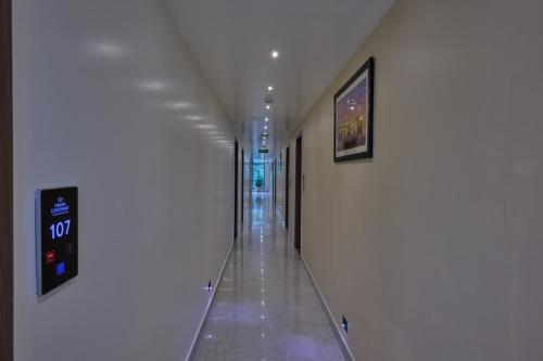 an empty hallway in a building with a sign on the wall at Grand Continent Mysore A Sarovar Portico Affiliate Hotel in Mysore