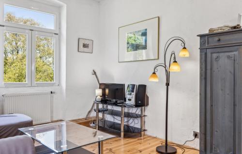 a living room with a tv and a glass table at Ferienwohnung Daniela in Rambin