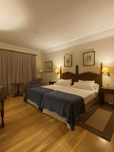 a bedroom with a large bed in a room at Parador de Vilalba in Villalba