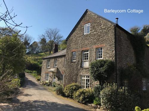 an old stone house on a dirt road at Watermill Cottages - 18th Century converted Mill 10 mins from beach in Dartmouth