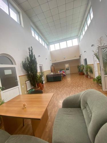 a large living room with a couch and a table at Tian-Shan Guest House in Balykchy