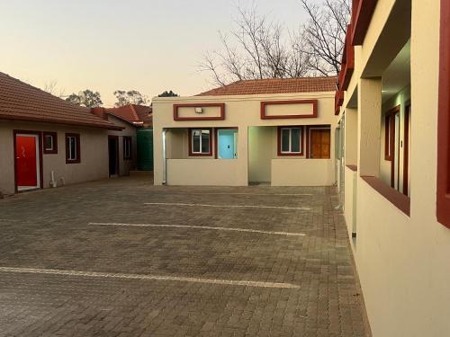 an empty parking lot in front of a building at Goldwell airport Lodge in Kempton Park