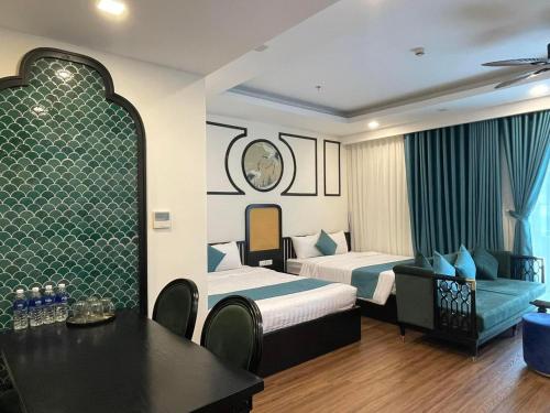 a hotel room with two beds and a table at FLC Sea Tower Quy Nhơn__Du Lịch Bình Định in Quy Nhon