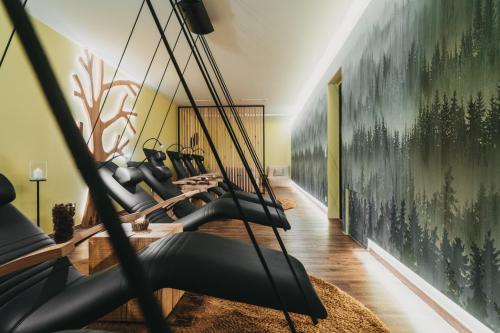 a gym with a bunch of exercise equipment at Hotel Eibl-Brunner 4-Sterne-Superior in Frauenau