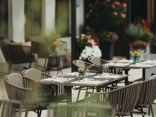 a group of tables and chairs with glasses on them at Hotel Eibl-Brunner 4-Sterne-Superior in Frauenau