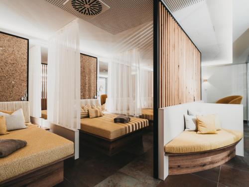 a bedroom with two beds and a mirror at Hotel Eibl-Brunner 4-Sterne-Superior in Frauenau