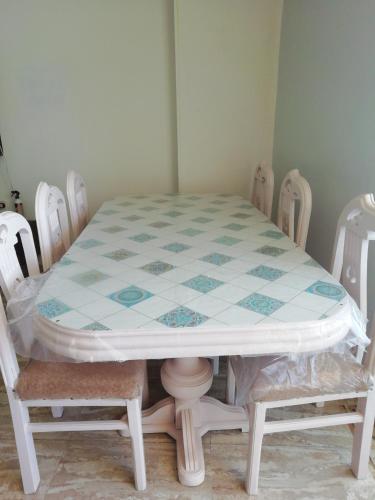 a table and chairs in a room with a table and a table and chairs at Panda House in Alexandria