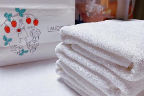 a stack of towels sitting next to a box of strawberries at Nissay Hotel Fukuoka - Vacation STAY 79962v in Fukuoka