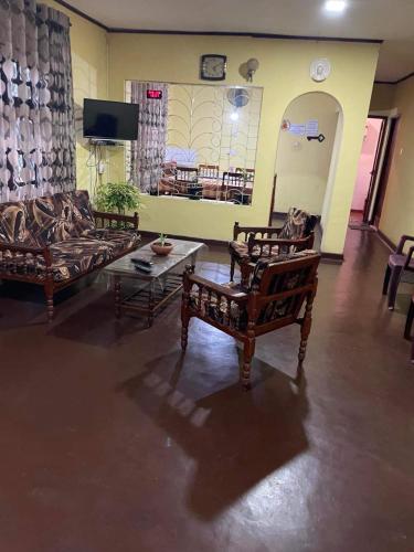 a living room with two couches and a table at Olivia HomeStay in Anuradhapura