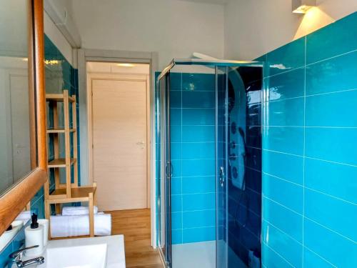 a bathroom with blue tiled walls and a sink at La Grotta Sardegna 3 Bedrooms in Urzulei