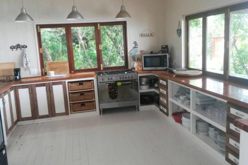 a kitchen with a stove and a counter top at Mar Azul 14 in Ponta Malongane