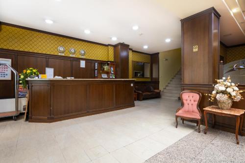 a lobby with a reception desk and a chair at Sveta Sofia Hotel in Sofia