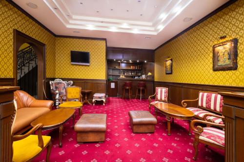 a waiting room with yellow walls and red carpet at Sveta Sofia Hotel in Sofia