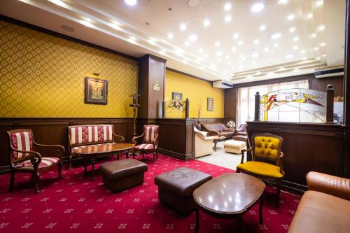 a waiting room with chairs and a table and chairs at Sveta Sofia Hotel in Sofia