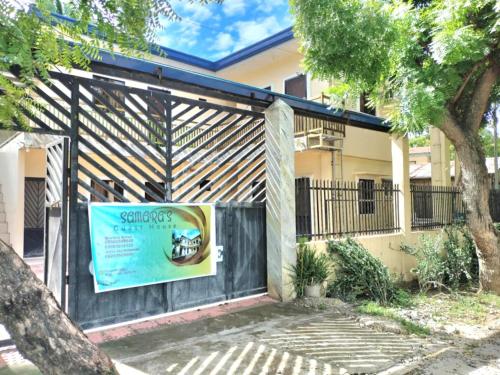 a gate to a house with a sign on it at Samara's Guests House in Pooc