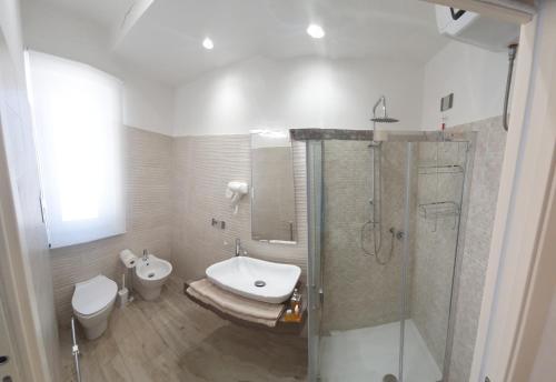 a bathroom with a shower and a toilet and a sink at la arenosa Bed and Breakfast in Messina