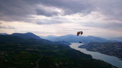 a person flying a kite over a body of water at Le Chalet Pastorale Pied Des Pistes in Les Orres