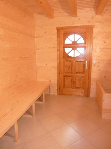 a room with a wooden door and a bench at Le Chalet Pastorale Pied Des Pistes in Les Orres