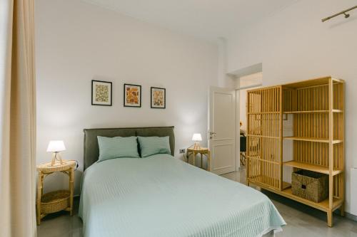 a bedroom with a bed and two end tables at Evgenia's House in Ampavris