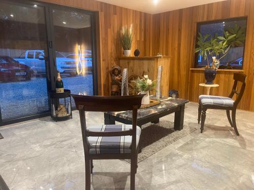 a dining room with a table and two chairs at Da Vinci Guest House & Guest Parking, A Real Gem in Crawley