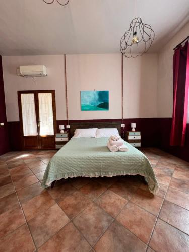 a bedroom with a bed with a stuffed animal on it at agriturismo l'arte dei semplici in Montalcino