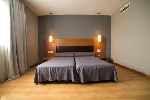 Uma cama ou camas num quarto em Hotel Romero Merida
