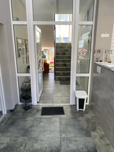 a hallway of a building with a staircase and a door at Apartmán HARMONY - Lipno nad Vltavou in Lipno nad Vltavou