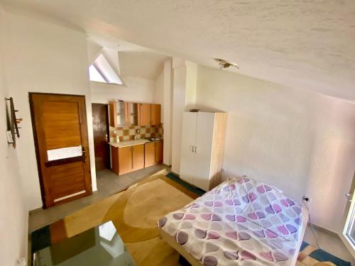 a room with a bed in the middle of a room at Apartman LITTLEHOME Travnik in Travnik
