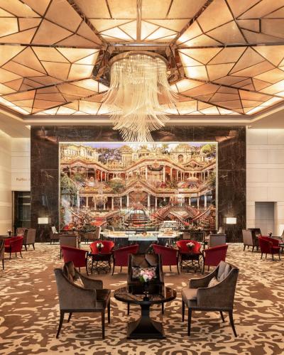 a lobby with a large painting on the wall at Raffles Istanbul in Istanbul