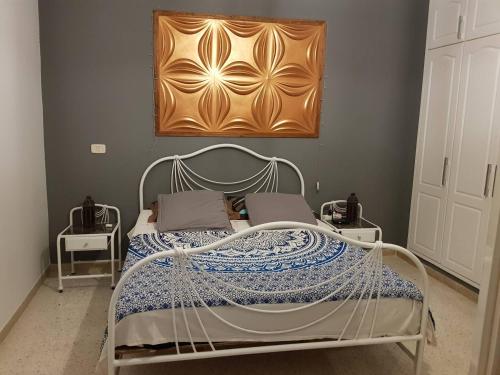 a bedroom with a bed with a metal frame at Nice apartment with nice view in El Aouina