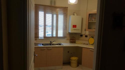 a small kitchen with a sink and a window at Nice apartment with nice view in El Aouina