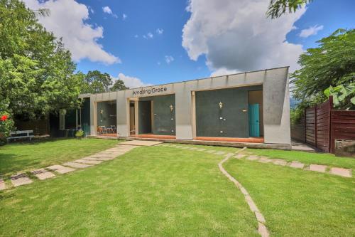 a house with a lawn in front of it at OwlStay Green Villa in Pinghe