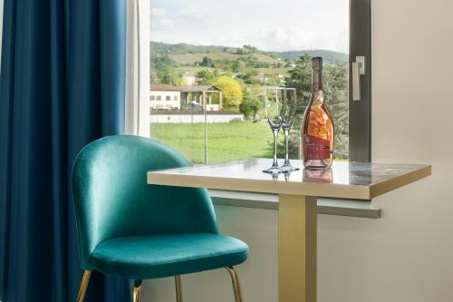 a table with a bottle of wine and a glass at Casale Auriga - Oltrepo' Pavese in Codevilla
