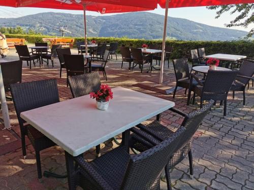 a table and chairs with tables and umbrellas at Alpengasthof Fernblick in Mönichkirchen