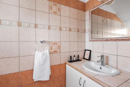 a bathroom with a sink and a white towel at Aqua Verde Luxury Villa by Nomads in Protaras