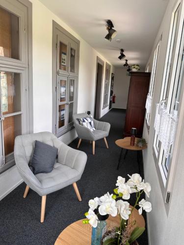 a living room with a couch and a chair at Gasthof Sternen Detligen in Detligen