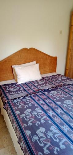 a bed with a pillow sitting on top of it at Secret garden villa 5 # 3 in Mangsit